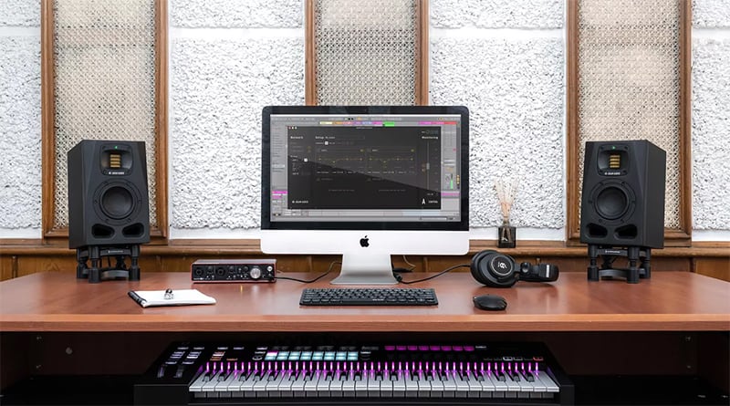 ADAM Audio A4V monitors next to a PC and keyboard.