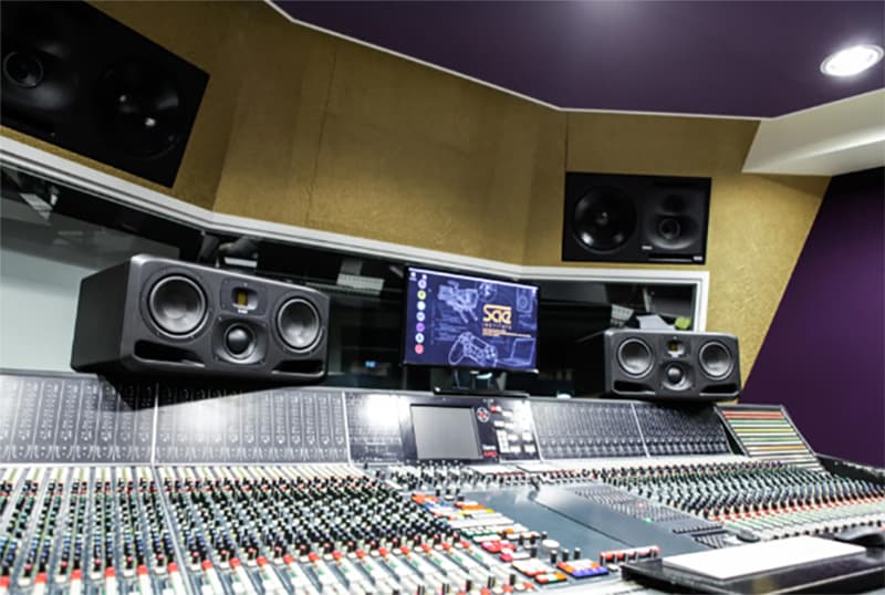 Mid Field studio monitors in a music production studio.