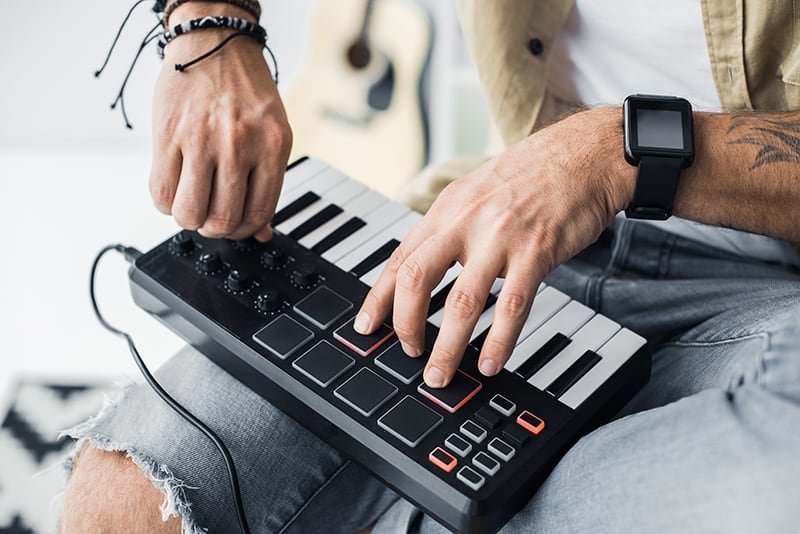 Man making music on a keyboard.