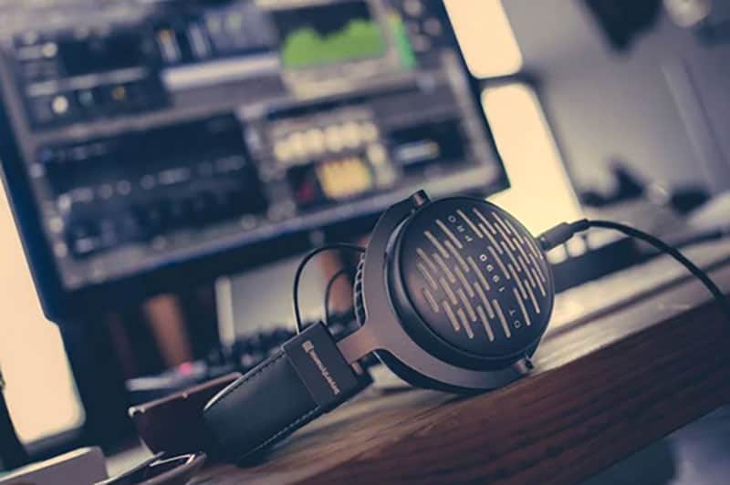 Beyerdynamic DT 1990 Pro sitting on a desk with a computer screen in the background.