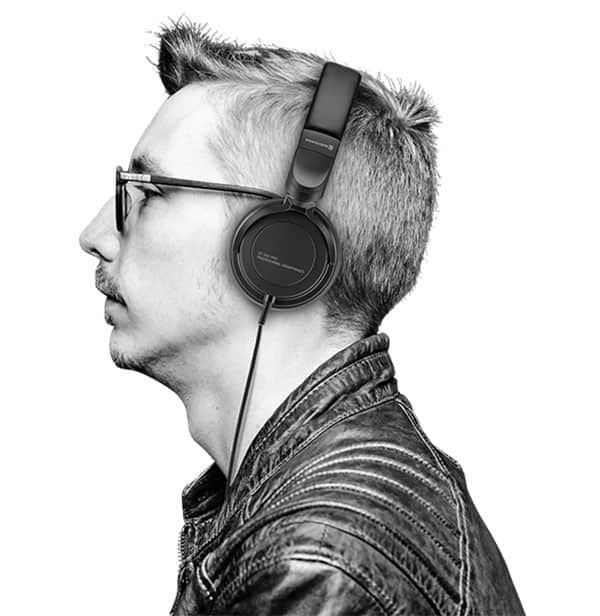 Man wearing the Beyerdynamic DT 240 PRO headphones.
