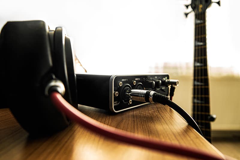 A pair of headphones connected to an external soundcard/amplifier