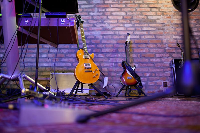 Photo of a music stage with guitars and other equipment.