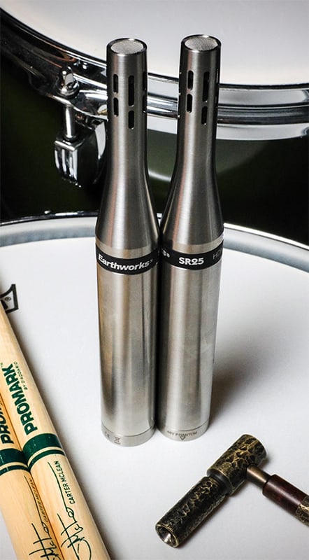 A pair of Earthworks SR25mp microphones sitting on top of a drum kit.