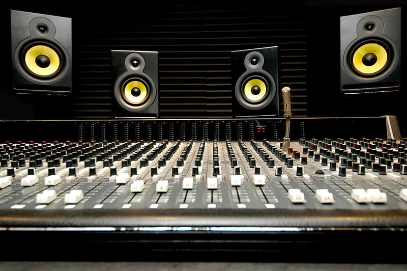 Music studio with speakers placed at head height.