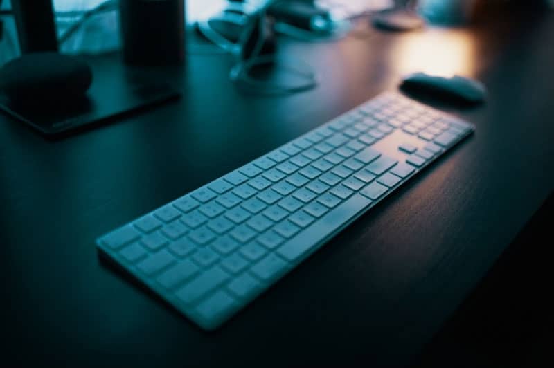 Photo of an office workspace with a wireless keyboard and mouse.