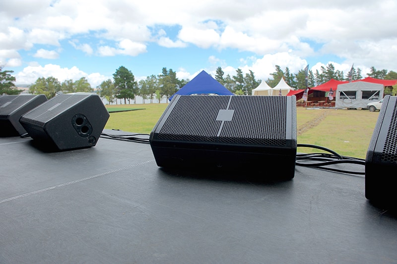 Speakers set up on a stage in a stage monitor position.