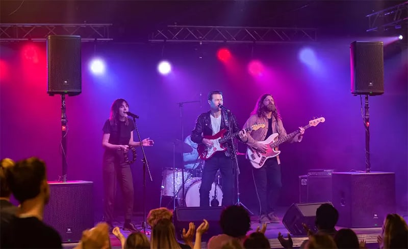 Band performing with JBL EON 710 loudspeakers.