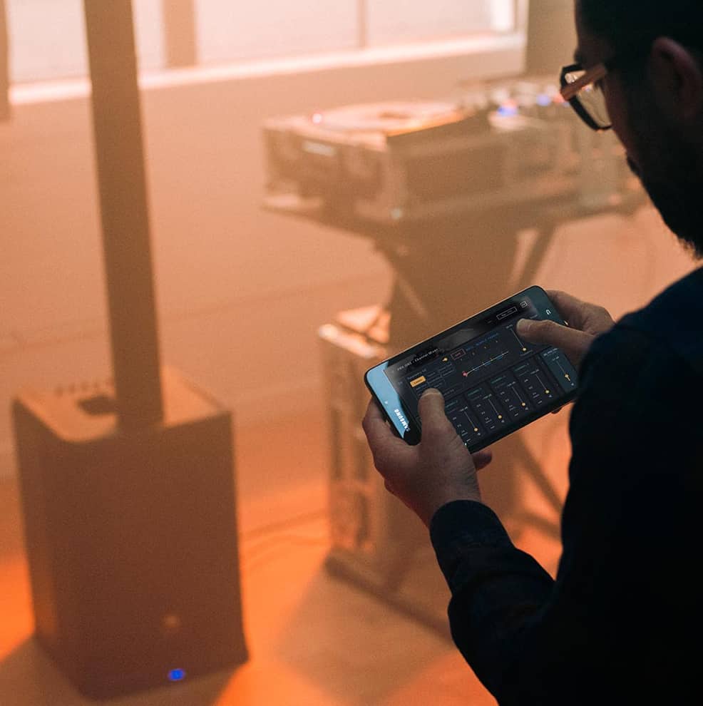 Man using the JBL Pro Connect App with a JBL PRX ONE.