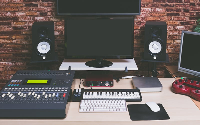 Photo of a workstation in a home music studio.