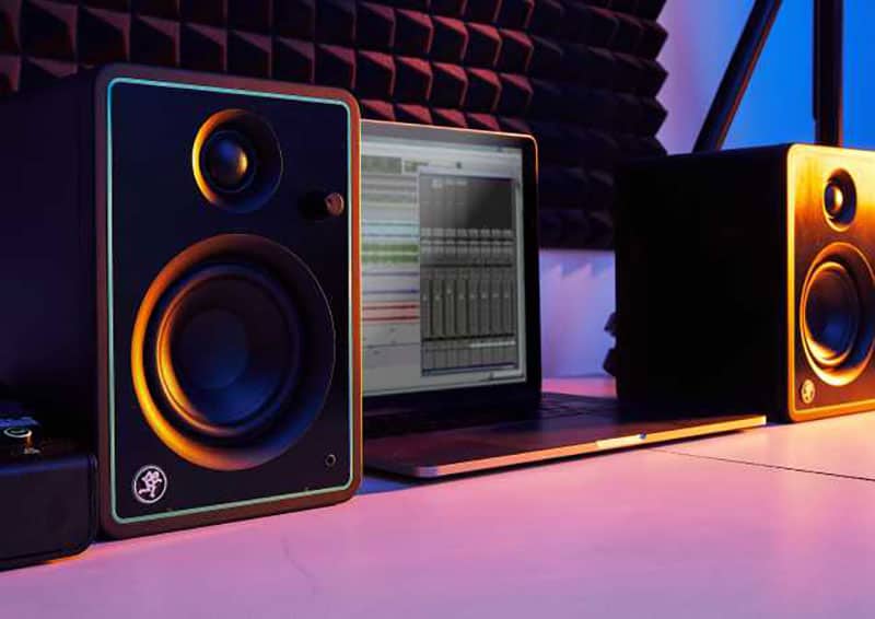Mackie CR8-XBT sitting next to a laptop.