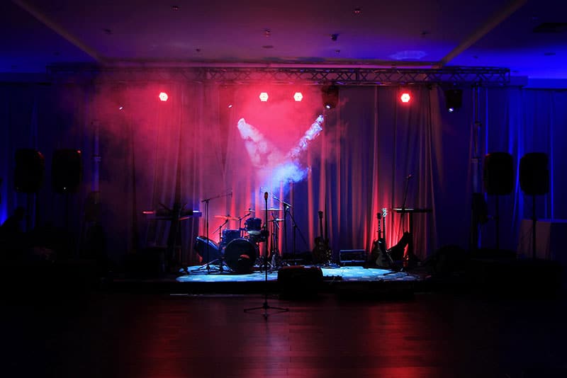 Photo of a stage with instruments, speakers and lighting.