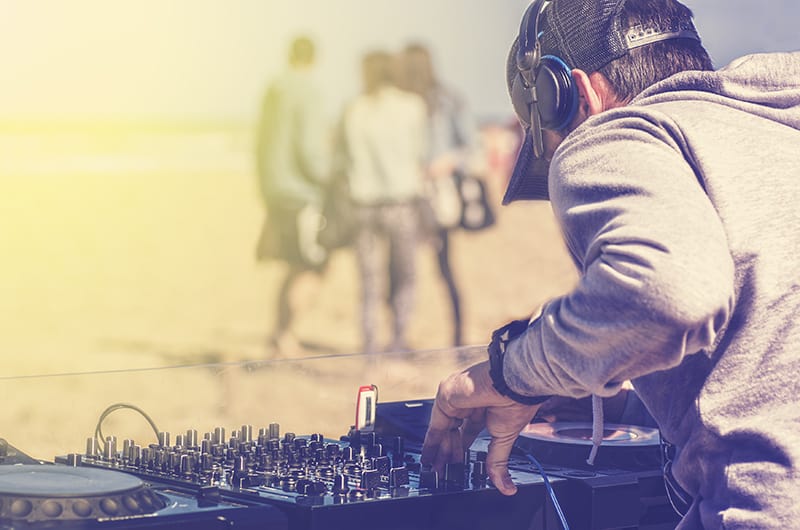 DJ playing at a beach.