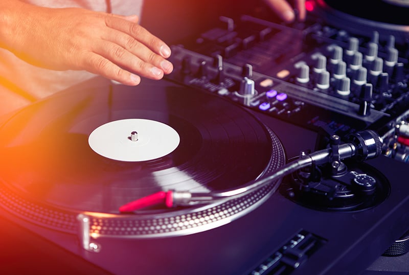 DJ using turntables in a club
