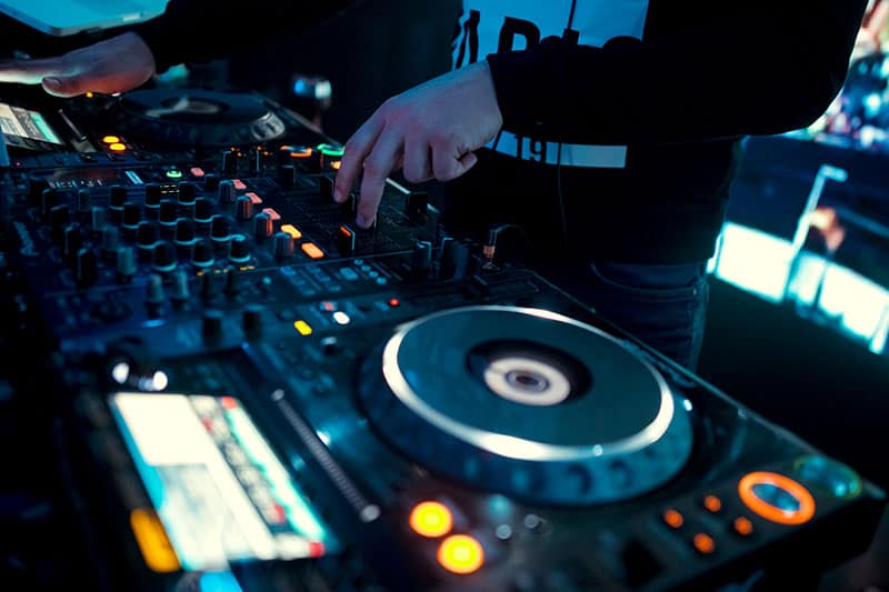 Pioneer DJ equipment in a club with a DJ playing music