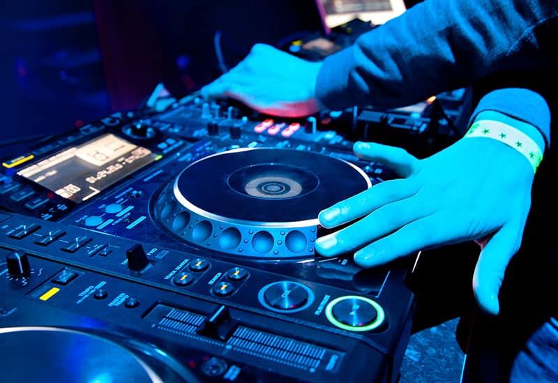 DJ playing music on professional equipment.