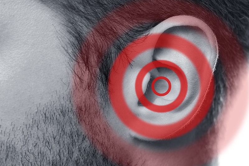 Clos up photo of a man's ear with illustrated pain circles.