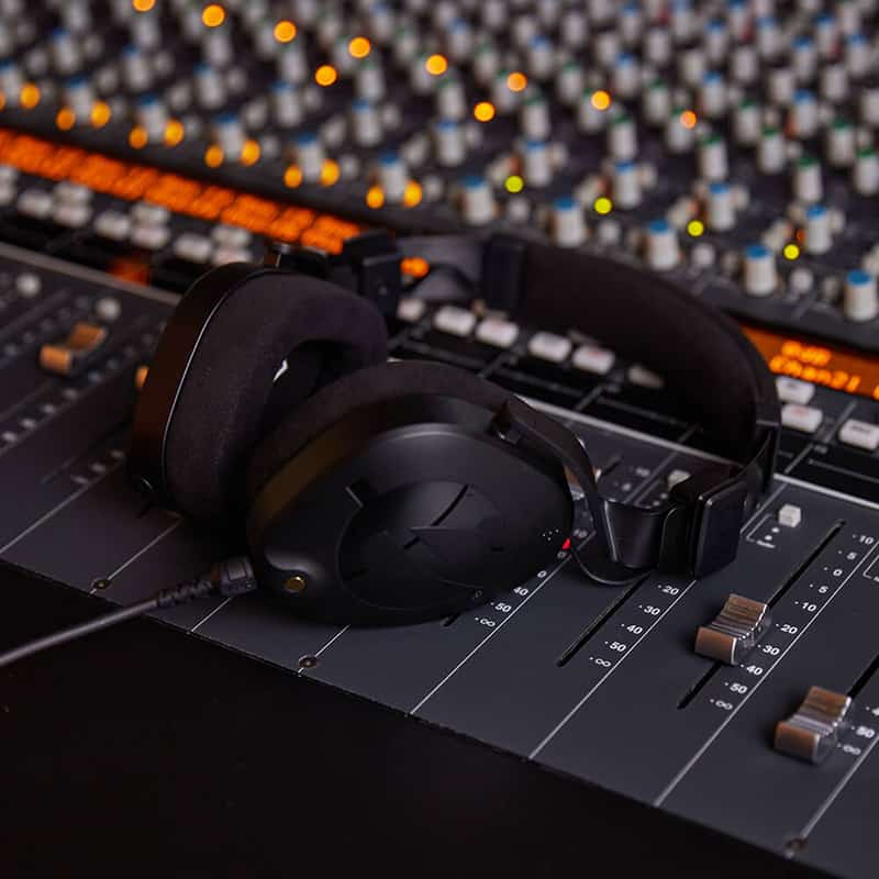 Rode NTH-100 sitting on a mixing desk.