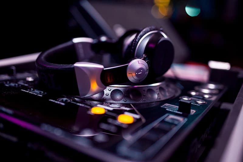 Headphones sitting on top of a DJ media player