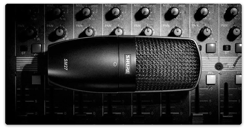 Shure SM27 sitting on a mixing desk.