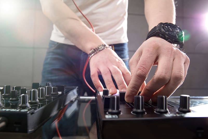 Man using DJ equipment.