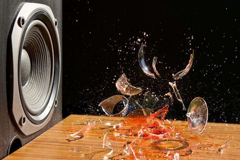 Photo of a speaker breaking a glass.