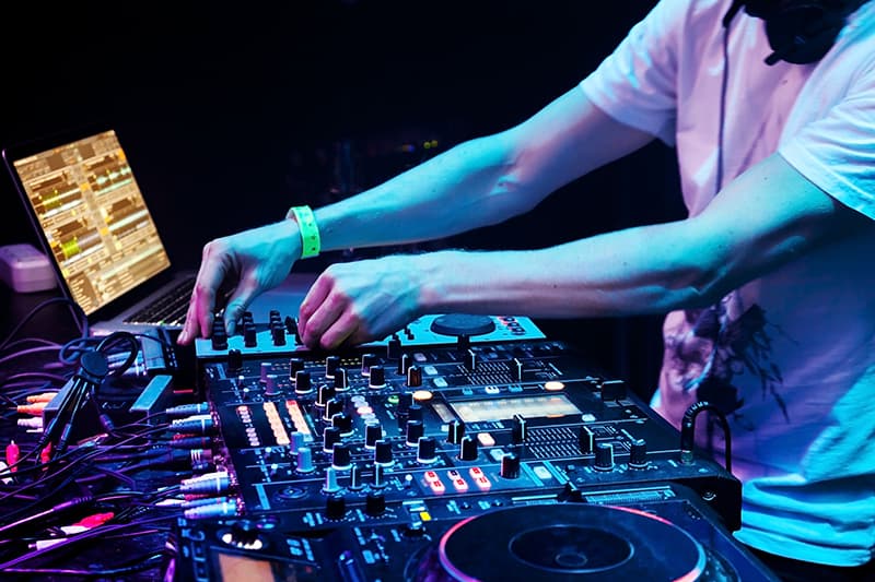 DJ using DJ software and DJ equipment.