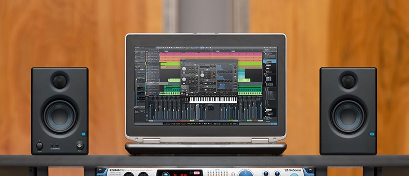 PreSonus Eris E3.5 monitors next to a laptop.