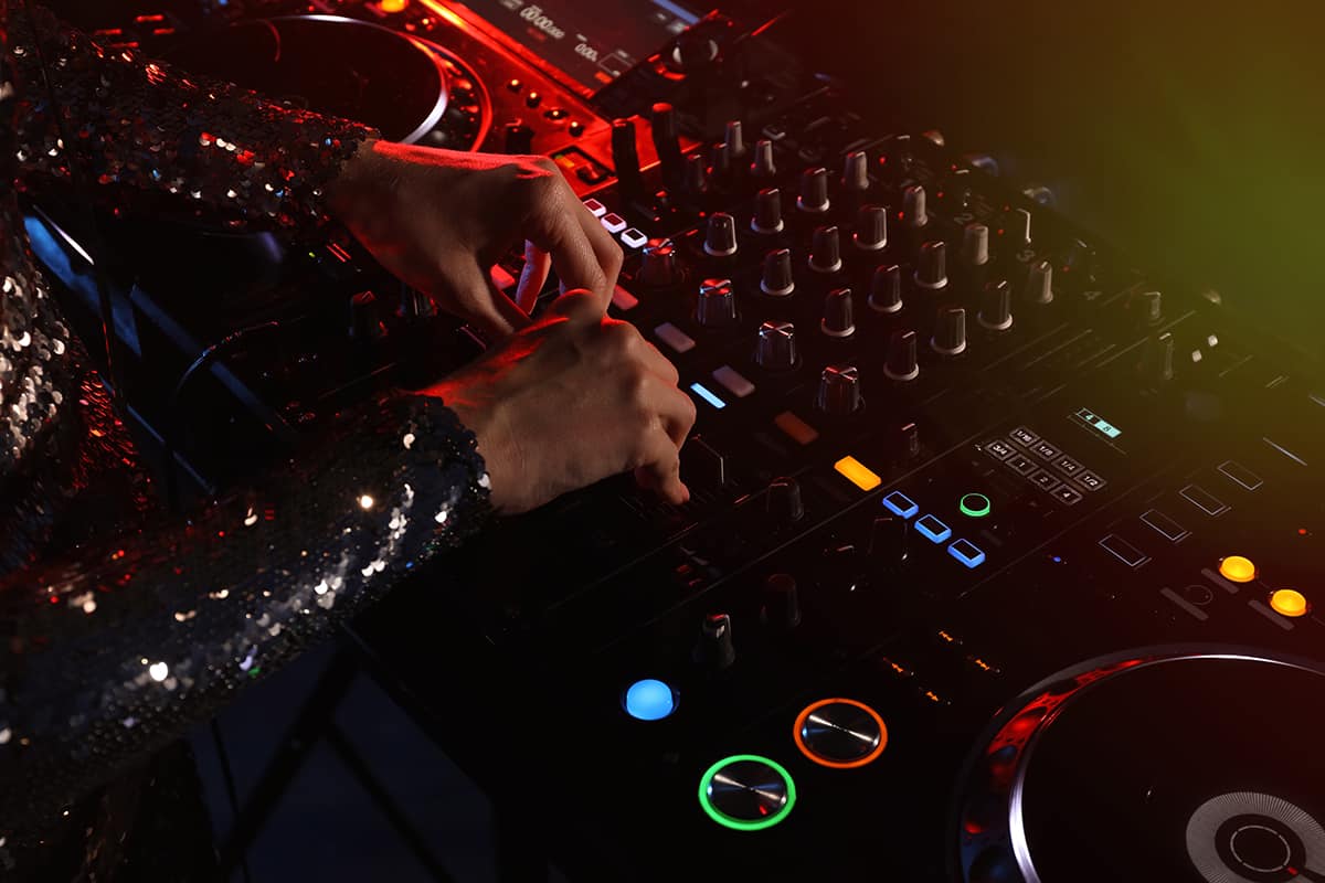 Female DJ using professional DJ equipment.