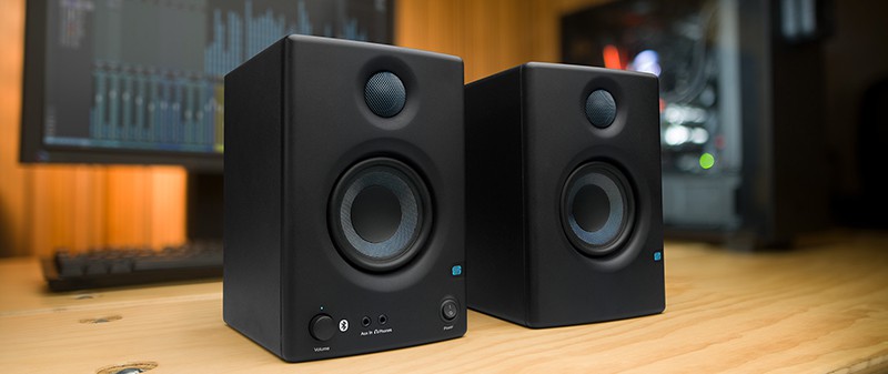 PreSonus monitors with a PC and monitor in the background.