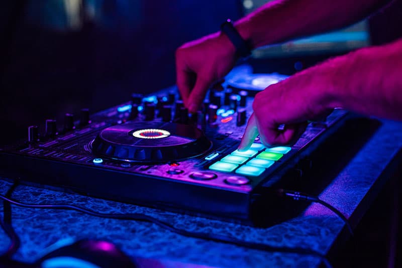 DJ using a DJ controller in a nightclub.