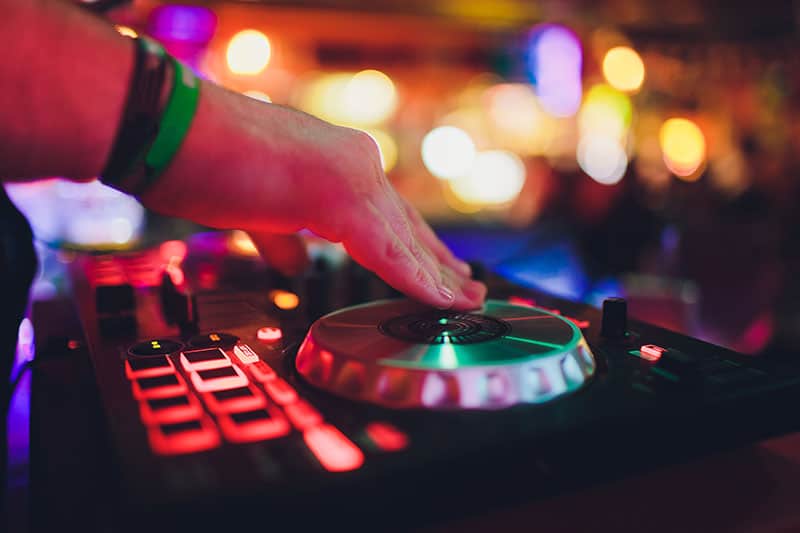 DJ scratching a DJ controller.