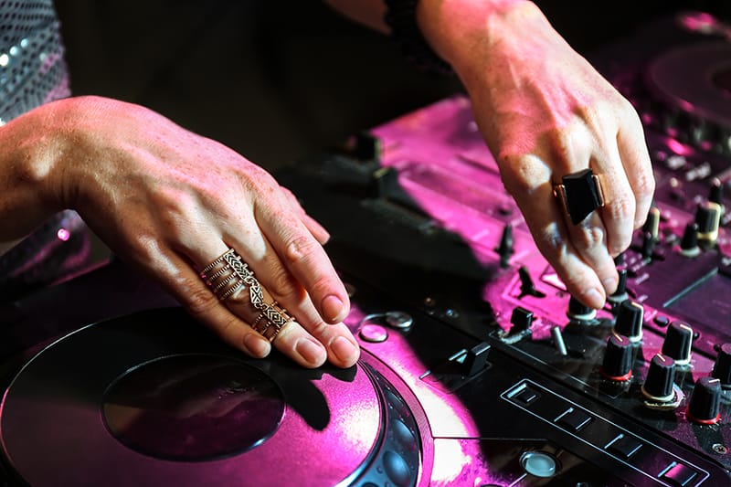 Close-up of a DJ using DJ equipment.