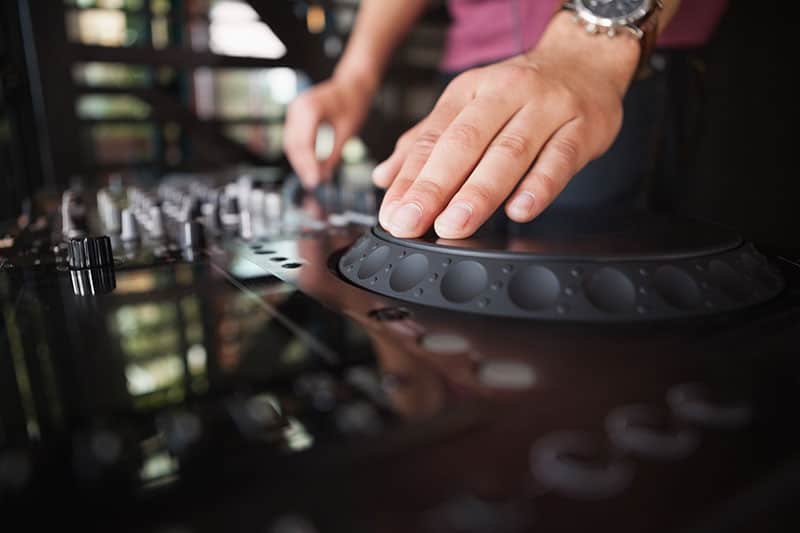 Close Up photo of a DJ using a jogwheel.