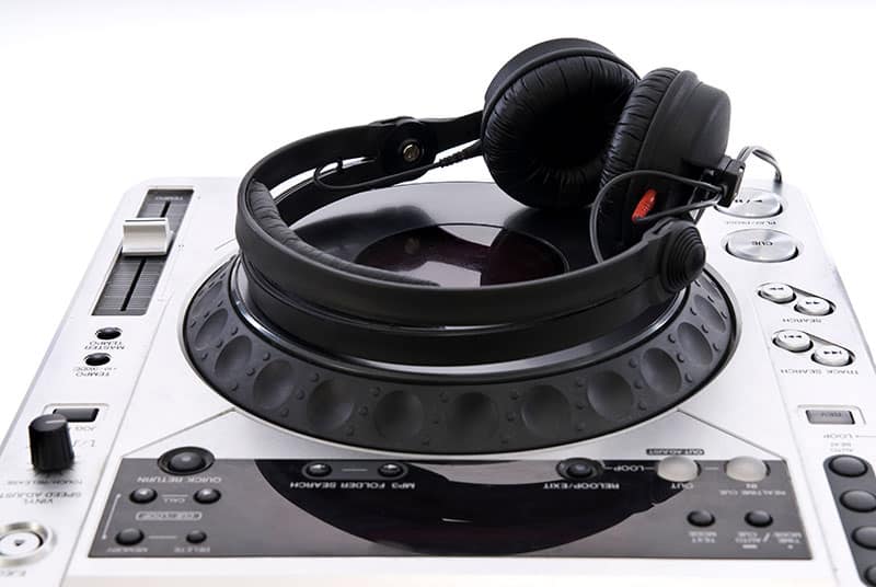 DJ Headphones sitting on top of a DJ mixer.