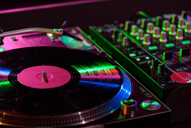 Close up photo of a DJ mixer and turntable.
