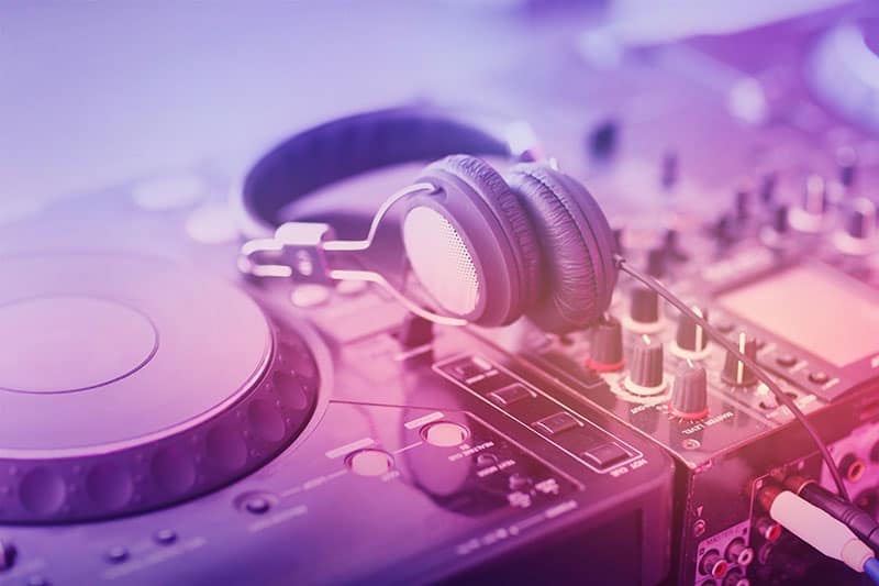 DJ headphones sitting on DJ equipment