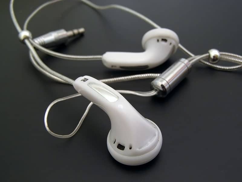 White earbuds on a dark background