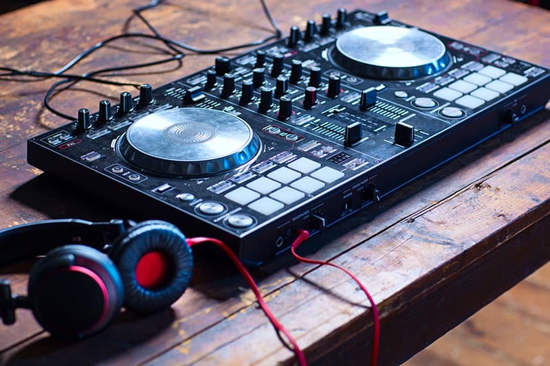 Dj controller on a table with headphones