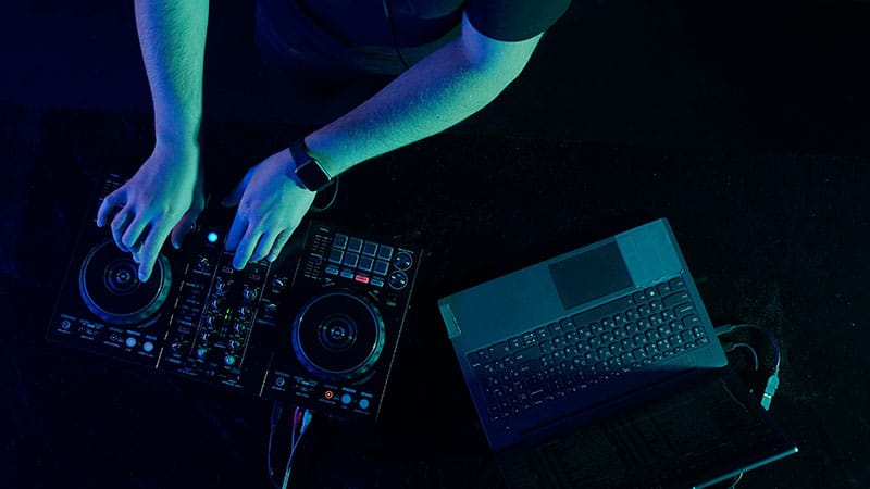 DJ using a DJ controller and laptop.