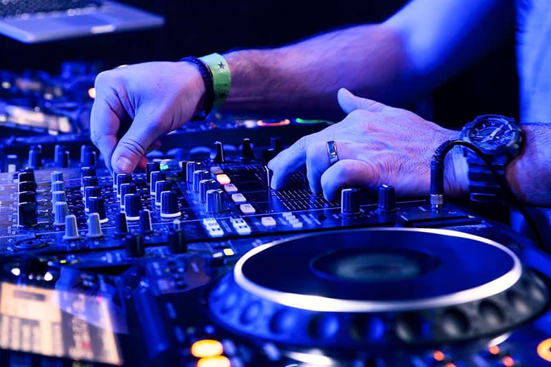 DJ using Pioneer Dj equipment in a club.
