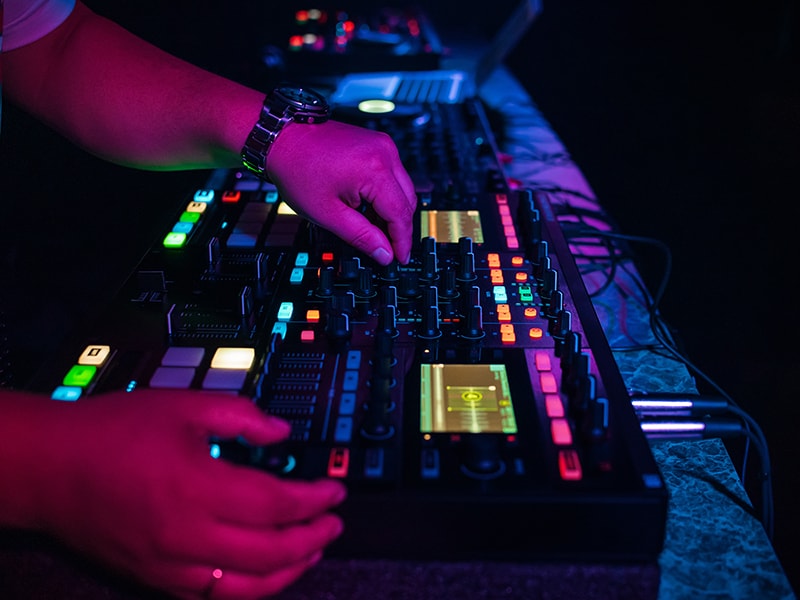 DJ using Native Instruments DJ gear at a club.